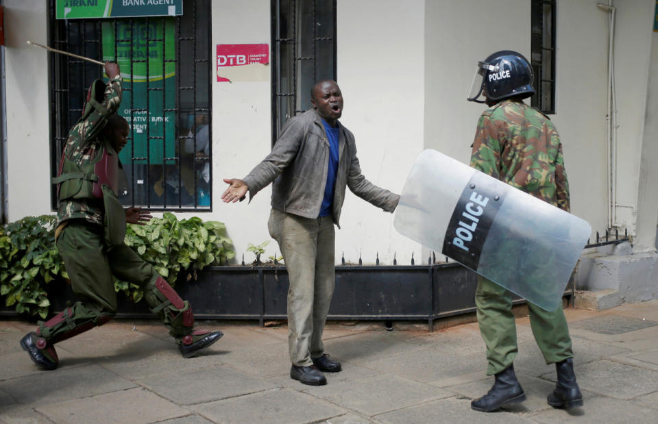 Policemen beat a protester during clashes in Nairobi, Kenya, May 16, 2016. (Reuters/Goran Tomasevic)