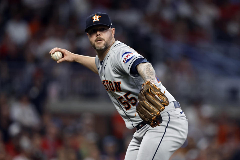 Houston Astros relief pitcher Ryan Pressly throws to first for the out on Atlanta Braves' Sam Hilliard during the ninth inning of a baseball game Friday, April 21, 2023, in Atlanta. (AP Photo/Butch Dill)