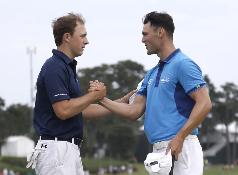 Jordan Spieth, left, and Martin Kaymer of Germany, shake hands at the end of the third round of The Players championship golf tournament at TPC Sawgrass, Saturday, May 10, 2014 in Ponte Vedra Beach, Fla. (AP Photo/Lynne Sladky)