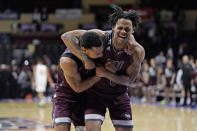 Freed-Hardeman guard JJ Wheat, left, celebrates with Freed-Hardeman guard Quan Lax after their NAIA men's national championship college basketball game against Langston, Tuesday, March 26, 2024, in Kansas City, Mo. Freed-Hardeman won 71-67. (AP Photo/Charlie Riedel)