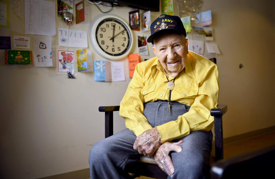 FILE - In this May 6, 2019, file photo, John R. Frey, a U.S. Army veteran, poses for a portrait next to cards and mementos he has been given at the Mervyn Sharp Bennion Central Utah Veterans Home in Payson, Utah. Frey, a World War II veteran whose family hoped to help him get 101 cards for his 101st birthday say they have been overwhelmed and grateful as well over 5,000 cards have been sent to Frey. (Isaac Hale/The Daily Herald via AP, File)