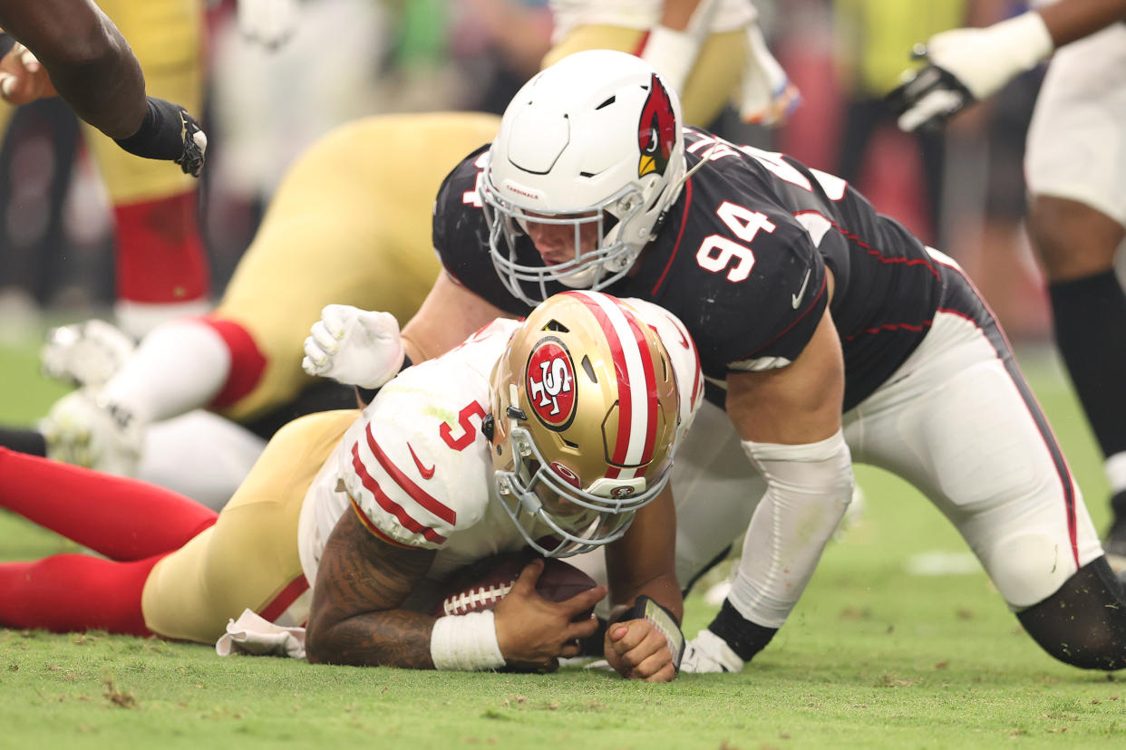 GLENDALE, ARIZONA - OCTOBER 10: Trey Lance #5 of the San Francisco 49ers is sacked by Zach Allen #94 of the Arizona Cardinals at State Farm Stadium on October 10, 2021 in Glendale, Arizona. (Photo by Christian Petersen/Getty Images)