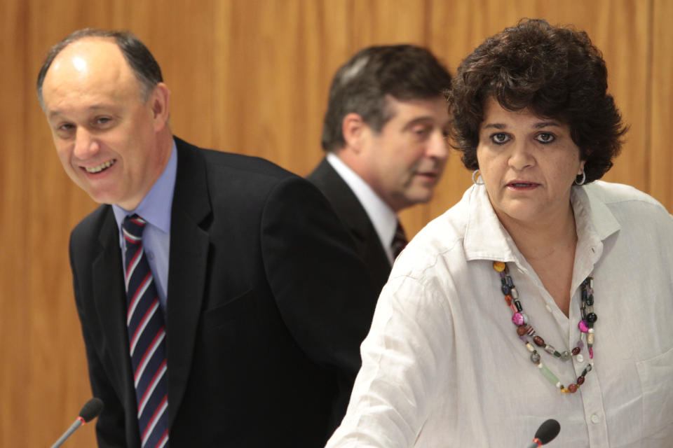 Brazil’s Environmental Minister Izabella Teixeira, right, and Agrarian Development Minister Pepe Vargas, left, arrive for a press conference at the Planalto presidential palace in Brasilia, Brazil, Friday, May 25, 2012. Agriculture Minister Mendes Ribeiro is behind center. Teixeira announced that President Dilma Rousseff used her line-item veto powers on a congressional bill that weakened the nation's benchmark environmental law protecting the Amazon. Environmentalists wanted Rousseff to veto the entire bill. (AP Photo/Eraldo Peres)