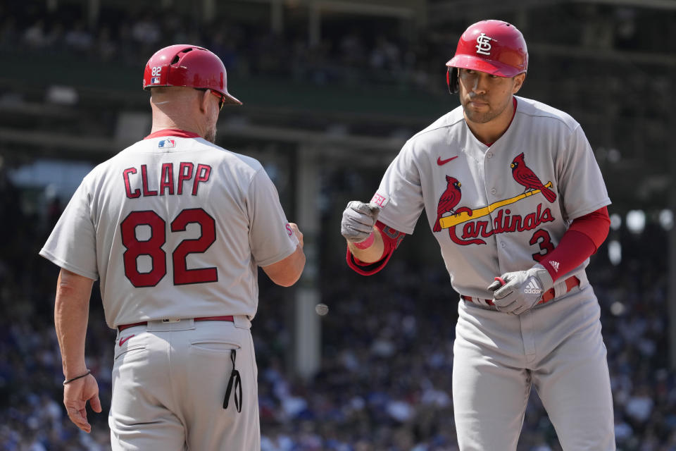St. Louis Cardinals' Dylan Carlson, right, celebrates with first base coach Stubby Clapp after hitting a one-run single during the sixth inning of a baseball game against the Chicago Cubs, Sunday, July 23, 2023, in Chicago. (AP Photo/Nam Y. Huh)