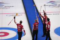 Team Canada celebrates after winning the men's curling bronze medal match against the United States at the Beijing Winter Olympics Friday, Feb. 18, 2022, in Beijing. (AP Photo/Nariman El-Mofty)