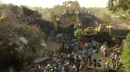 Excavators work after a landslide at a garbage dump on the outskirts of Addis Ababa, Ethiopia in this still image taken from a video from March 12, 2017. REUTERS/Reuters TV