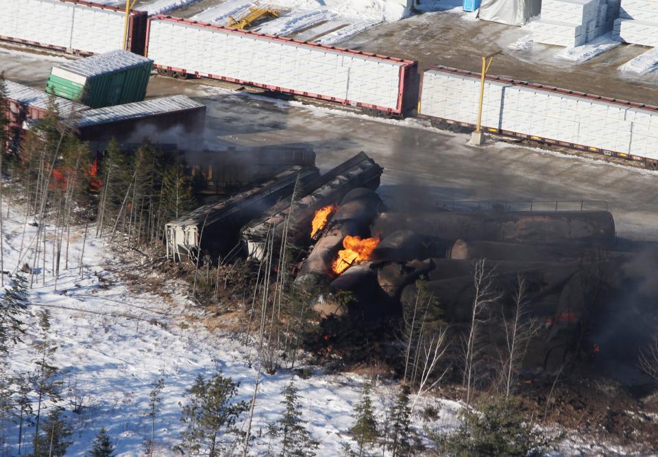 This aerial photo shows derailed train cars burning in Plaster Rock, New Brunswick on Wednesday, Jan. 8, 2014. A Canadian National Railway freight train carrying crude oil and propane derailed Tuesday night in a sparsely populated region of northwestern New Brunswick. More than 100 residents remained evacuated from their homes. There were no deaths or injuries. (AP Photo/The Canadian Press, Tom Bateman)