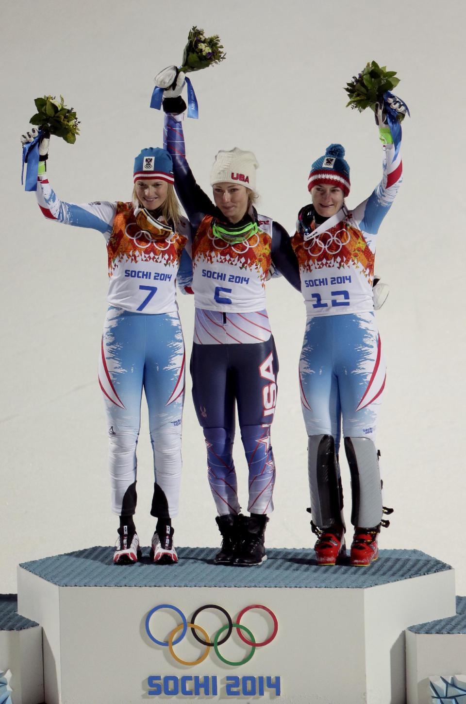 Women's gold medalist, United States' Mikaela Shiffrin, center, silver medalist Austria's Marlies Schild, left, and bronze medalist Kathrin Zettel photo for photographers during the flower ceremony for the women's slalom at the Sochi 2014 Winter Olympics, Friday, Feb. 21, 2014, in Krasnaya Polyana, Russia. (AP Photo/Charlie Riedel)