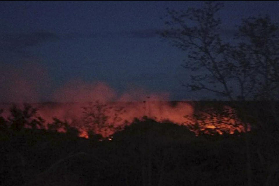 Flame rises from burning houses in Kinma village, Pauk township, Magwe division, central Myanmar, Tuesday June 15, 2021. Residents said people are missing after military troops burned the village. (AP Photo)