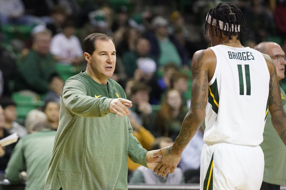 Baylor head coach Scott Drew, left, reaches to forward Jalen Bridges (11) at a timeout during the second half of an NCAA college basketball game against the Northwestern State in Waco, Texas, Tuesday, Dec. 20, 2022. Baylor won 58-48. (AP Photo/LM Otero)