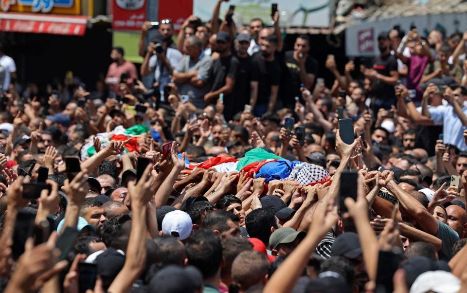 Mourners carry the bodies of Palestinian militants of the Al-Aqsa Martyrs' Brigade Hussein Taha and Islam Sabbouh, who were killed in an Israeli raid, during a funeral procession in the West Bank city of Nablus - JAAFAR ASHTIYEH/AFP