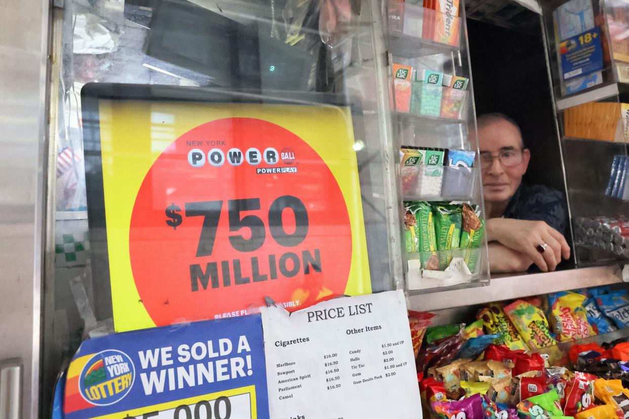 A Powerball lottery advertisement is displayed on a newsstand.