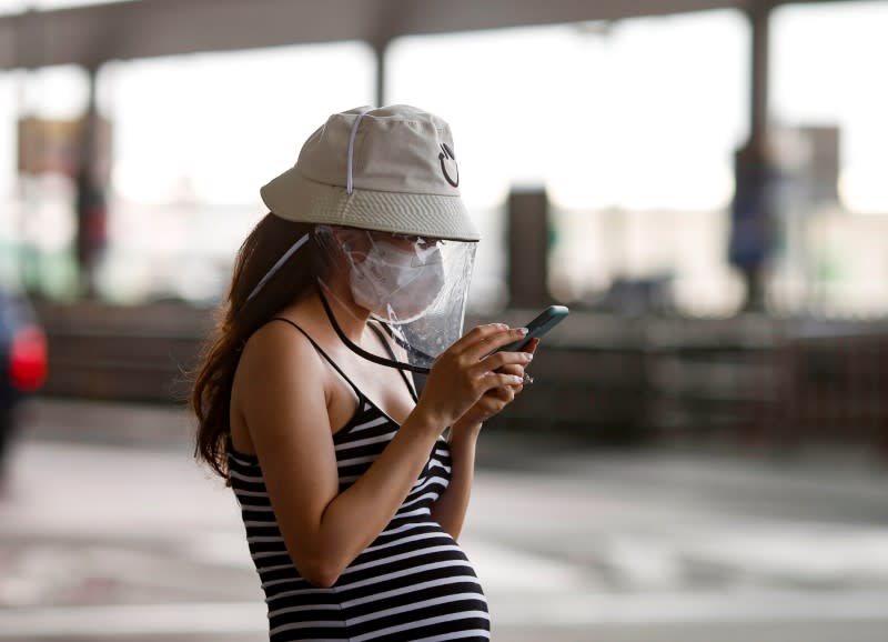 FILE PHOTO: A pregnant woman wears a protective face mask due to the coronavirus disease (COVID-19) outbreak, as she came out from Suvarnabhumi Airport at Bangkok