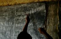 An election official tallies the totals after vote-counting at a polling station in the Kamenge neighbourhood of Bujumbura on July 21, 2015