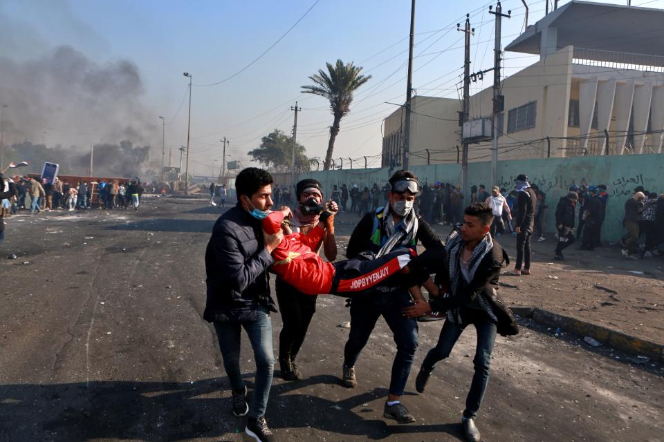 An injured protester is rushed to a hospital during clashes between security forces and anti-government protesters in central Baghdad, Iraq, Monday, Jan. 20, 2020. Security forces fired tear gas and live rounds on Monday wounding over a dozen protesters, medical and security officials said, in continuing violence as anti-government demonstrators make a push to revive their movement in Baghdad and the southern provinces. (AP Photo/Khalid Mohammed)