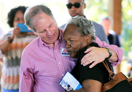 Democratic Alabama U.S. Senate candidate Doug Jones greets a supporter while campaigning at an outdoor festival in Grove Hill, Alabama. REUTERS/Mike Kittrell