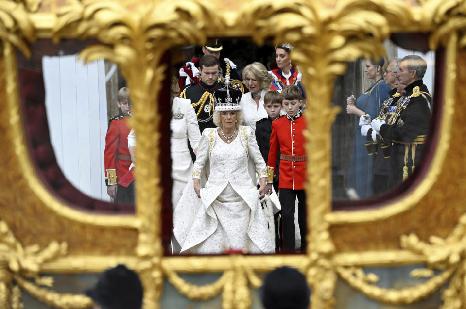 FILE - Britain's Queen Camilla leaves Westminster Abbey following her coronation ceremony, in London, Saturday, May 6, 2023. Queen Camilla, once seen as the scourge of the House of Windsor, the woman at the heart of King Charles III’s doomed marriage to the late Princess Diana, has emerged as one of the monarchy’s most prominent emissaries. With Charles and the Princess of Wales sidelined by illness, Camilla has stepped lightly into the void, increasing her schedule of appearances and taking on the all-important role of keeping the royal family firmly in the public eye — of being seen. (Toby Melville, Pool via AP, File)