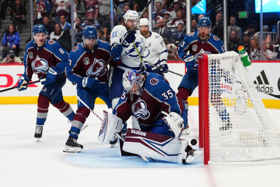 Colorado Avalanche goaltender Darcy Kuemper (35) lets the puck slip past for a goal by Tampa Bay Lightning left wing Ondrej Palat, not seen, during the third period in Game 5 of the NHL hockey Stanley Cup Final, Friday, June 24, 2022, in Denver. (AP Photo/Jack Dempsey)