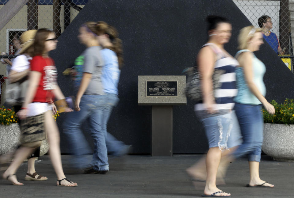 A memorial to the seven killed in the Aug. 13, 2011 stage collapse during a Sugarland concert at the Indiana State Fair, goes virtually unnoticed by fair visitors on opening day of the 2012 run of the State Fair in Indianapolis, Aug. 3, 2012. (AP Photo/Michael Conroy)