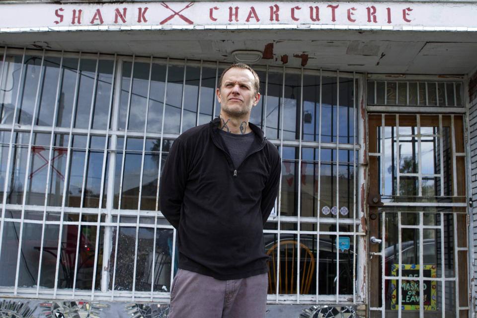 Kristopher Doll poses for a portrait in New Orleans, Saturday, Jan. 30, 2021. After a monthslong struggle, Doll closed his doors in November and is now looking for work. He said he was able to stay afloat until late summer, when a weekly boost in unemployment benefits ran out and business plummeted. (AP Photo/Dorthy Ray)