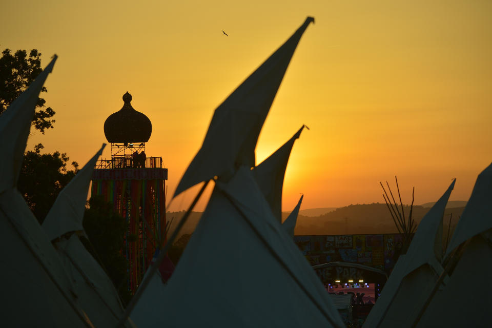 The sun sets behind the ribbon tower on day two of Glastonbury. The festival continues until Sunday (Photo by Jim Dyson/Getty Images)