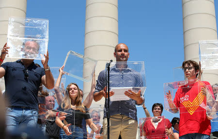 FILE PHOTO - Manchester City's manager Pep Guardiola holds a ballot box during a pro-independence rally in Barcelona, Spain June 11, 2017. REUTERS/Albert Gea/File Photo