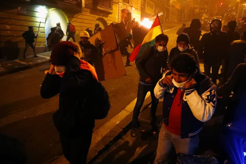 Protesters clash with riot police while demonstrating against Bolivian President Evo Morales in La Paz