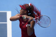 Naomi Osaka, of Japan, serves to Viktorija Golubic, of Switzerland, during second round of the tennis competition at the 2020 Summer Olympics, Monday, July 26, 2021, in Tokyo, Japan. (AP Photo/Patrick Semansky)