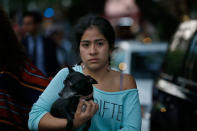 <p>A woman holds her dog in the aftermath of a 7.2-magnitude earthquake that shook Mexico City, Friday, Feb. 16, 2018. (Photo: Marco Ugarte/AP) </p>