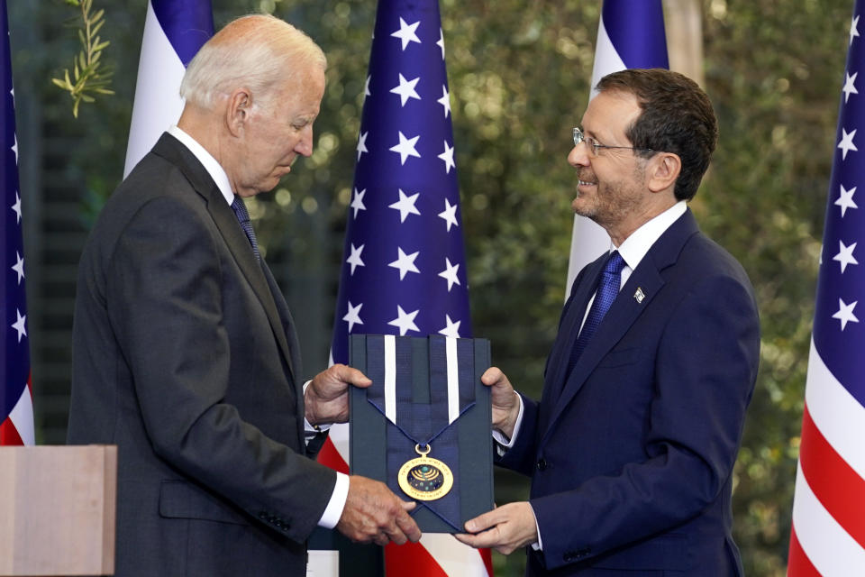 President Joe Biden receives the Israeli Presidential Medal of Honor from Israeli President Isaac Herzog, Thursday, July 14, 2022, in Jerusalem. (AP Photo/Evan Vucci)