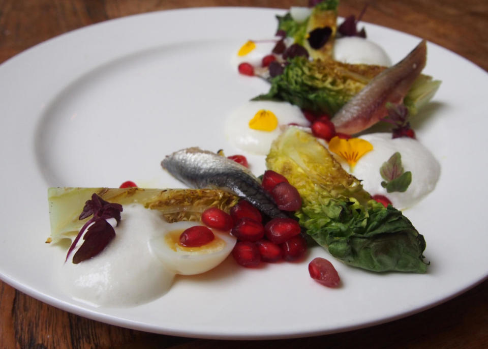 <p>Cogollos Con Idiazabal Y Anchoas Ahumadas</p><p>(Grilled Spanish sucrine lettuce, Idiazabal cheese form, smoked anchovies and pomegranate)</p><p>260 calories</p>