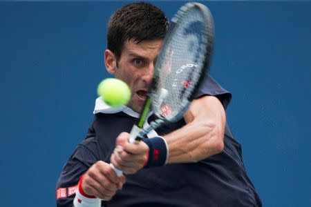 Novak Djokovic of Serbia returns a shot to Andreas Seppi of Italy during their third round match at the U.S. Open Championships tennis tournament in New York, September 4, 2015. REUTERS/Adrees Latif
