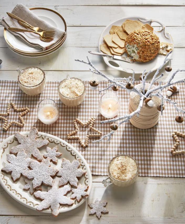 <p>Are you feeling the Scandinavian vibes too? This neutral-toned table is as sophisticated as it is spirited.</p><p><strong>To make the wooden bead stars</strong><strong>:</strong> Draw a five-point star on paper. Make a loop in one end of a piece of silver craft wire. Thread beads on wire, bending wire per drawing as you go. Feed loose end of wire through loop, crimp, and cut.</p><p><strong>To make the acorn tree: </strong>Paint nuts with white craft paint, leaving caps natural. Attach a loop of twine with hot glue. Hang from a spray-painted branch set inside a spool of twine.</p><p><a class="link rapid-noclick-resp" href="https://www.amazon.com/Foraineam-200pcs-Natural-Unfinished-Wooden/dp/B07RT7ML99?tag=syn-yahoo-20&ascsubtag=%5Bartid%7C10052.g.38125716%5Bsrc%7Cyahoo-us" rel="nofollow noopener" target="_blank" data-ylk="slk:SHOP WOODEN BEADS">SHOP WOODEN BEADS</a></p>