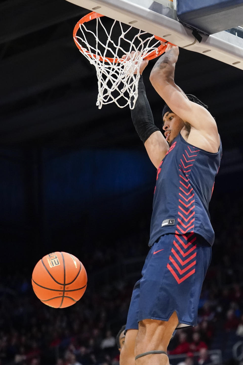 Dayton forward Toumani Camara hangs on the rim after a dunk during the second half of an NCAA college basketball game, Saturday, Nov. 19, 2022, in Dayton, Ohio. Dayton defeated Robert Morris, 60-51. (AP Photo/Joshua A. Bickel)