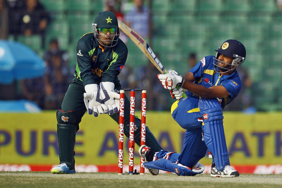 Sri Lanka’s Lahiru Thirimanne, right, plays a shot, as Pakistan’s wicketkeeper Umar Akmal watches during the opening match of the Asia Cup one-day international cricket tournament between them in Fatullah, near Dhaka, Bangladesh, Tuesday, Feb. 25, 2014. (AP Photo/A.M. Ahad)