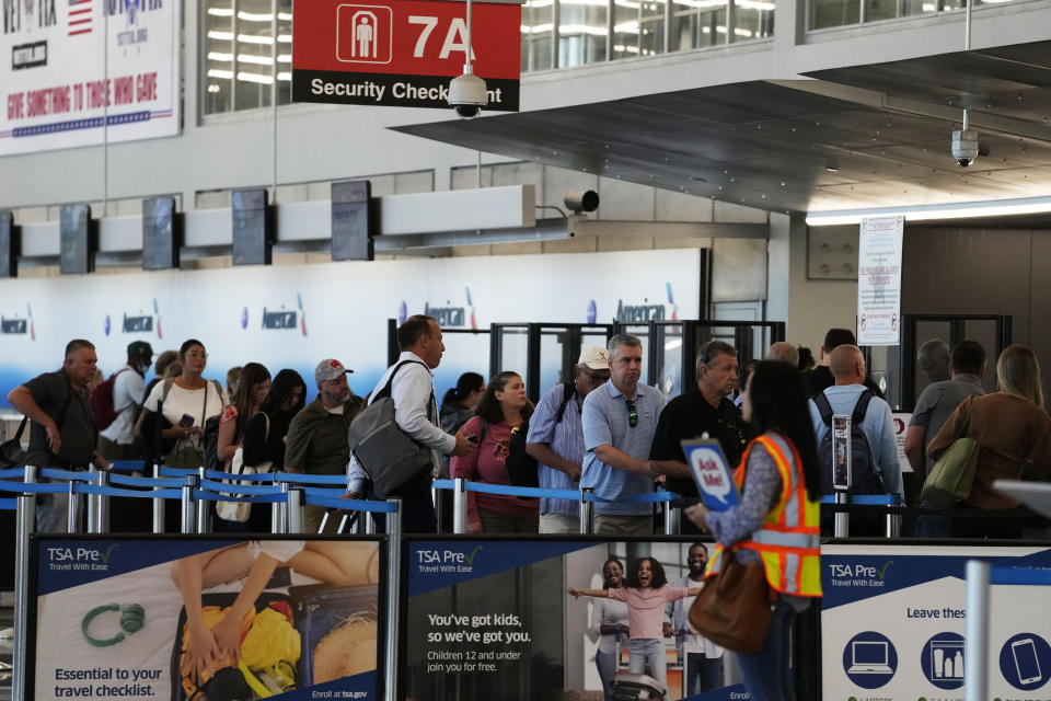 Travelers wait to go through security check point at O'Hare International Airport in Chicago, Thursday, Aug. 31, 2023. The Federal Aviation Administration predicts that this will be the third busiest holiday weekend of the year so far, behind only the Juneteenth weekend, which included Father's Day, and the Presidents Day break.(AP Photo/Nam Y. Huh)