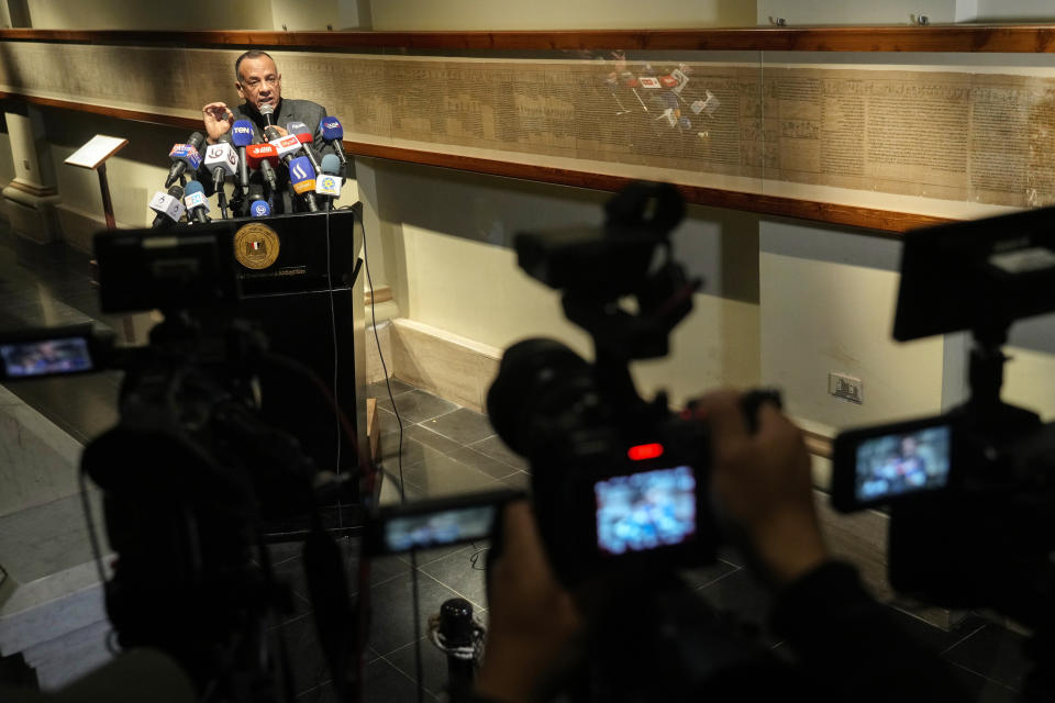 Mostafa Waziri, secretary-general of the Supreme Council of Antiquities speaks in front of a 16-meter long papyrus named Waziri-1 Papyrus containing inscriptions from the Book of the Dead dating back to 50 BC, at the Egyptian museum in Cairo, Egypt, Monday, Feb. 20, 2023. Egypt's ministry of tourism and antiquities unveiled a renovated wing within its 120-year-old museum, the first stage of a broader replenishment program for the palatial building. (AP Photo/Amr Nabil)