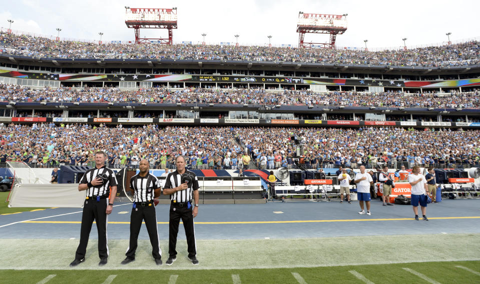 <p>Officials stand on the sideline of the Seattle Seahawks during the playing of the national anthem before an NFL football game between the Seahawks and the Tennessee Titans Sunday, Sept. 24, 2017, in Nashville, Tenn. Neither team came out onto the field for the anthem. (AP Photo/Mark Zaleski) </p>