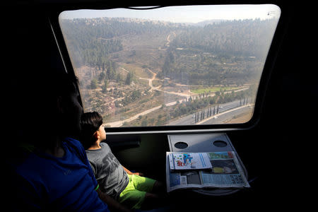 Passengers look out of a window as they travel on Israel's new high-speed rail line from Ben Gurion International Airport to Jerusalem September 25, 2018. REUTERS/Amir Cohen