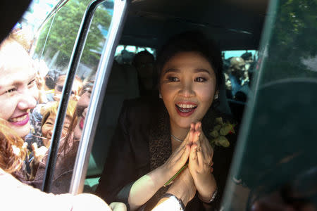 Ousted former Thai prime minister Yingluck Shinawatra greets supporters as she leaves the Supreme Court in Bangkok, Thailand, August 1, 2017. REUTERS/Athit Perawongmetha