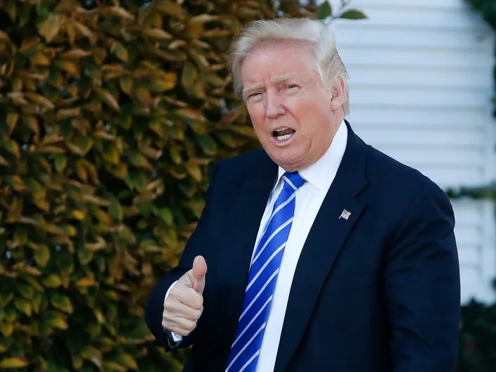 Former President Donald Trump gives the thumbs-up as he arrive at the Trump National Golf Club Bedminster clubhouse in Bedminster, New Jersey, on Saturday, November 19, 2016.