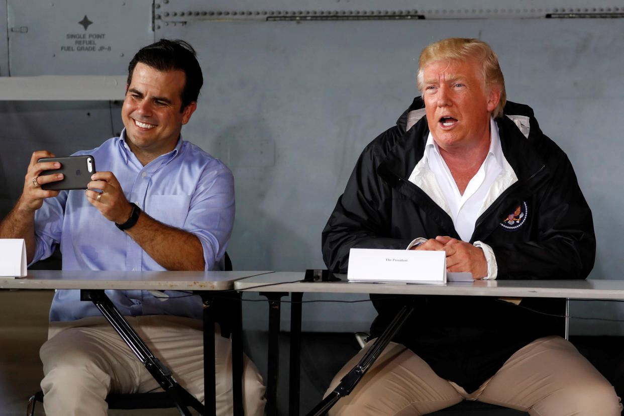 Puerto Rico Gov. Ricardo Rossello, left, takes a picture as he and President Donald Trump receive a briefing on hurricane relief efforts on Oct. 3, 2017. (Photo: Jonathan Ernst / Reuters)