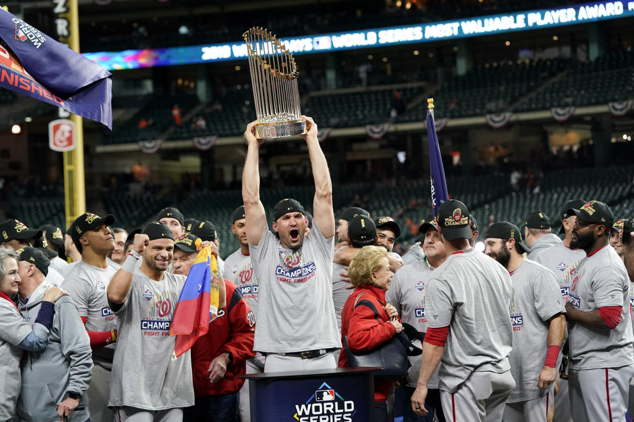 CORRECTS ID TO FIRST BASEMAN RYAN ZIMMERMAN, NOT CATCHER YAN GOMES - Washington Nationals first baseman Ryan Zimmerman celebrates with the trophy after Game 7 of the baseball World Series against the Houston Astros, Wednesday, Oct. 30, 2019, in Houston. The Nationals won 6-2 to win the series. (AP Photo/David J. Phillip)