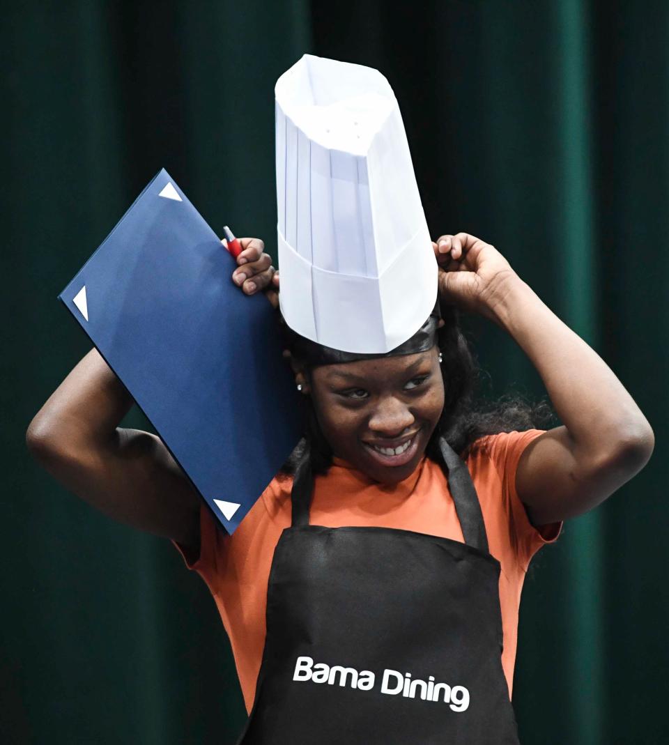 May 9 2024; Tuscaloosa, AL, USA; Bama Dining signee Make McNeal dons her chef’s hat during the Signing Day for students entering the workforce through the West Alabama Works program at Shelton State.