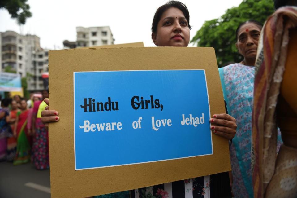 An Indian Hindu holds a placard as she takes part in a rally against 'Love Jihad', in Ahmedabad on July 22, 2018.<span class="copyright">SAM PANTHAKY/AFP via Getty Images</span>