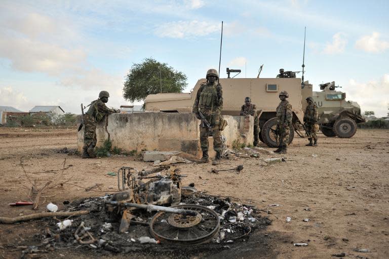 African Union-United Nations soldiers in Somalia stand guard in the town of Kurtunwaarey in the Lower Shabelle region of Somalia after liberating it from Al Shabab, August 31, 2014