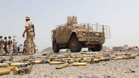 A Southern Resistance fighter walks past an armoured personnel carrier taken by resistance fighters from Houthi fighters in the Emran outskirts of Yemen's southern port city of Aden July 13, 2015. REUTERS/Stringer