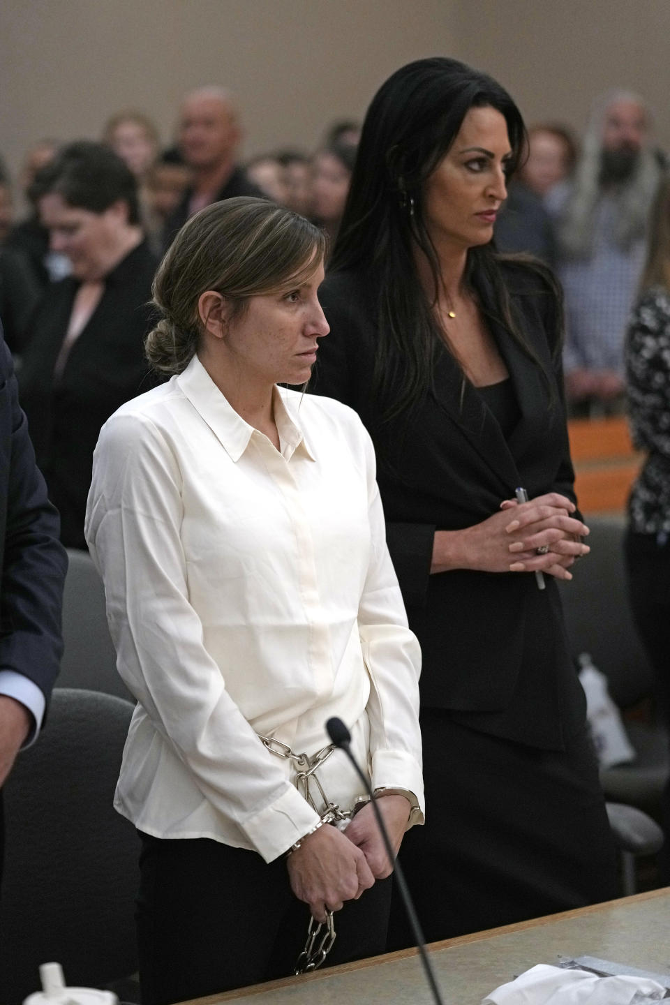 Kouri Richins, a Utah mother of three who authorities say fatally poisoned her husband then wrote a children's book about grieving, looks on as she stands with her attorney Skye Lazaro during a bail hearing Monday, June 12, 2023, in Park City, Utah. A judge ruled to keep her in custody for the duration of her trial. (AP Photo/Rick Bowmer, Pool)