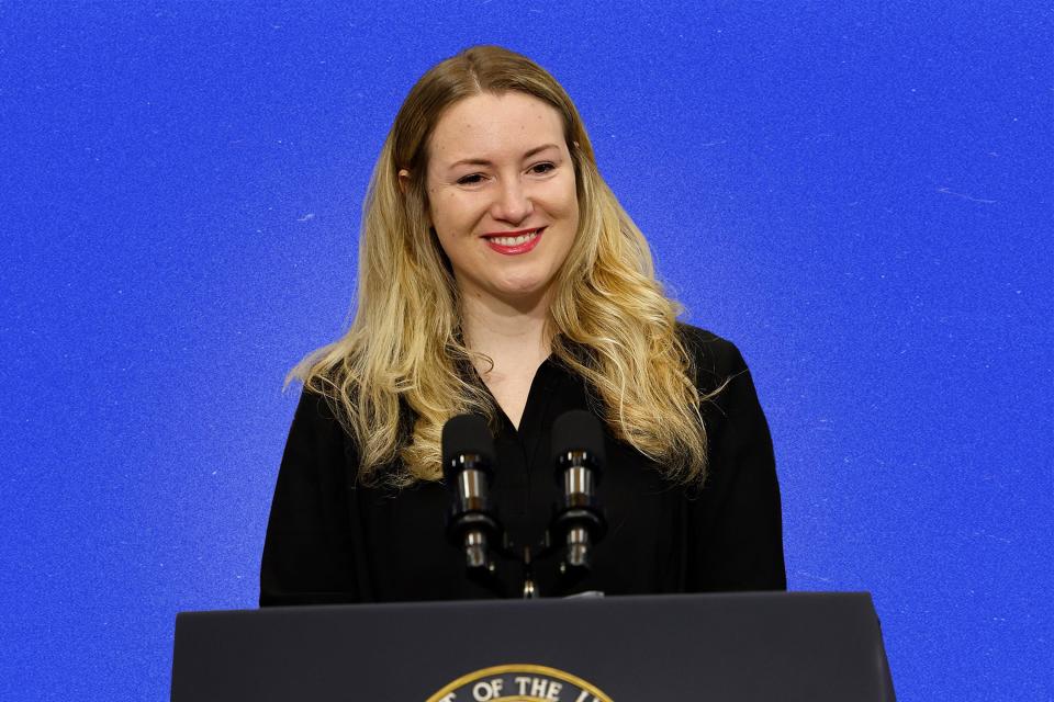 Kate Cox stands behind a podium.