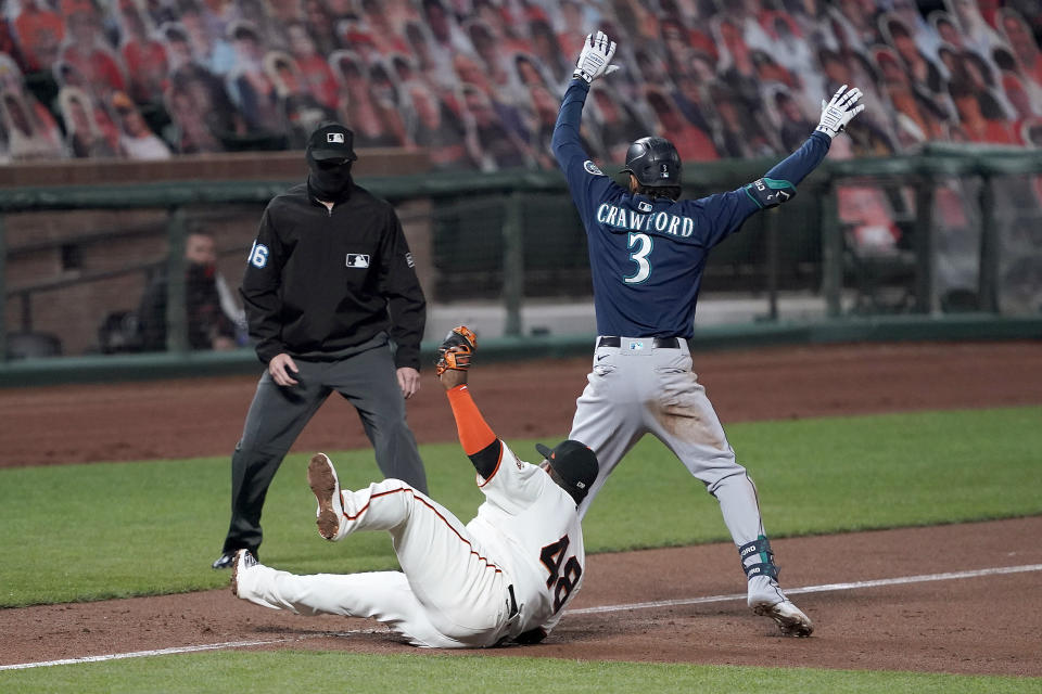 San Francisco Giants third baseman Pablo Sandoval (48) holds up the ball in his glove after tagging out Seattle Mariners' J.P. Crawford (3), who tried to advance to third after hitting a double during the second inning of a baseball game Tuesday, Sept. 8, 2020, in San Francisco. (AP Photo/Tony Avelar)